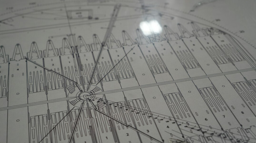 Printed charts and graphs spread across a desk